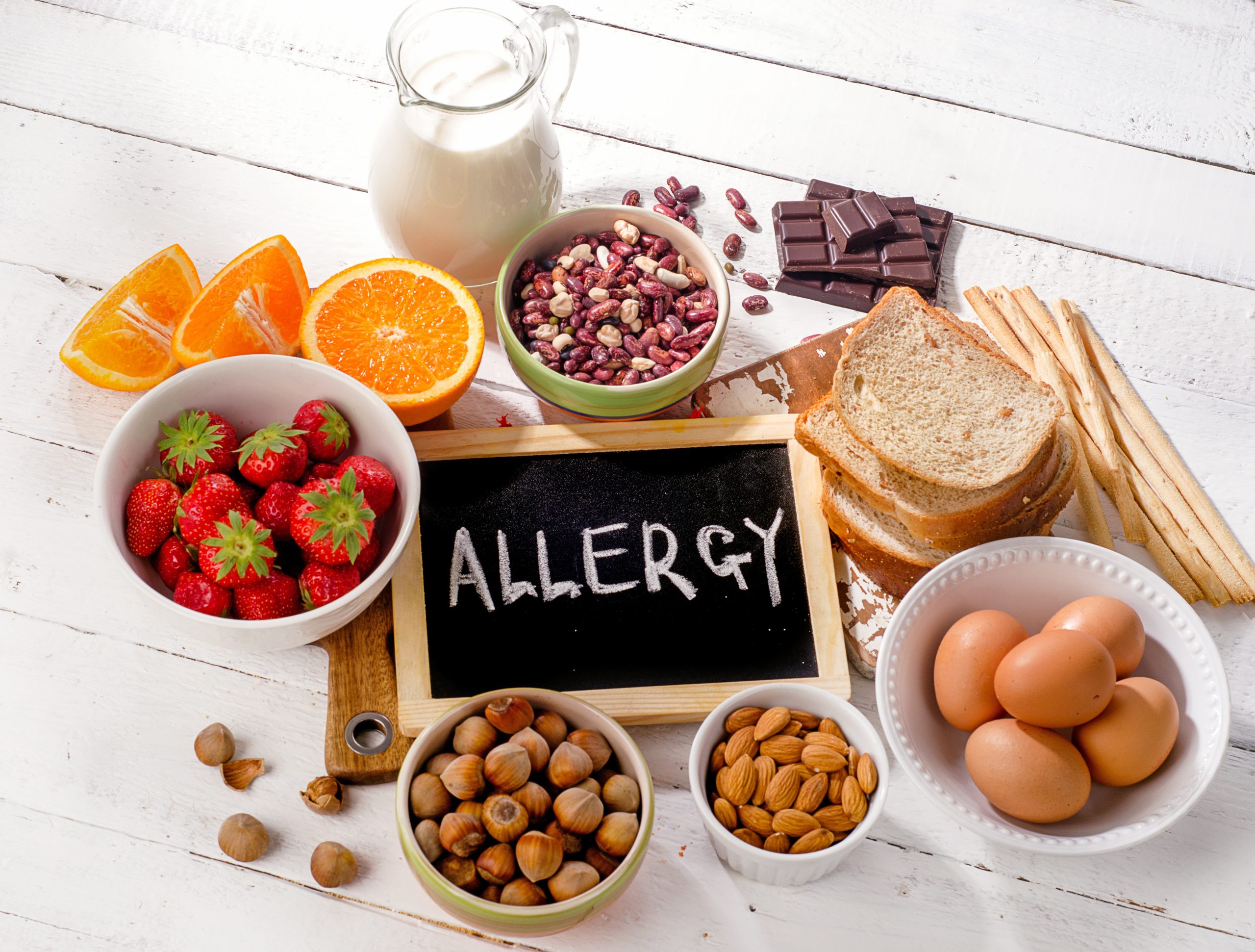 Food allergy. Allergic food on wooden background.